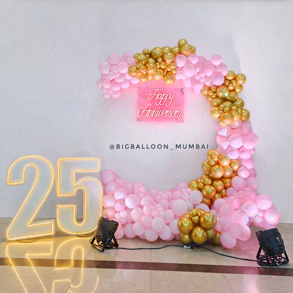 Grand 25th wedding anniversary celebration with champagne gold backdrop and luxury lighting